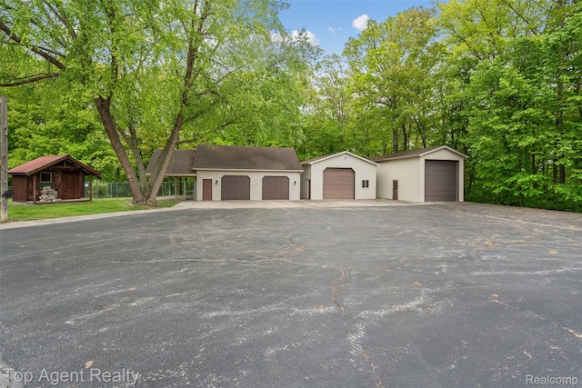 7386 Card Rd, Smiths Creek, MI 48074 - view of front facade with an outdoor structure and view of wooded area