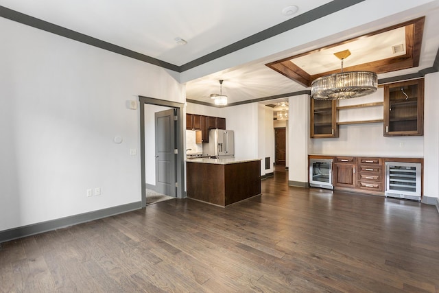 27 Library St NE Unit 301, Grand Rapids, MI 49503 - kitchen featuring beverage cooler, stainless steel fridge with ice dispenser, a tray ceiling, and dark wood-style floors