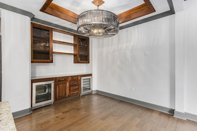 27 Library St NE Unit 301, Grand Rapids, MI 49503 - indoor dry bar with wine cooler, a tray ceiling, baseboards, and dark wood-style floors