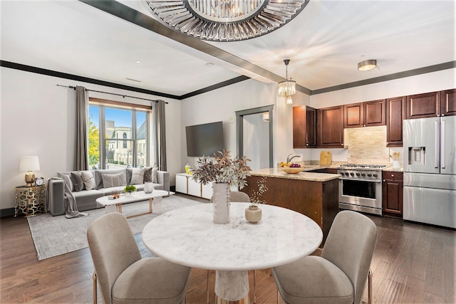 27 Library St NE Unit 301, Grand Rapids, MI 49503 - kitchen with appliances with stainless steel finishes, dark wood-type flooring, open floor plan, crown molding, and light stone counters