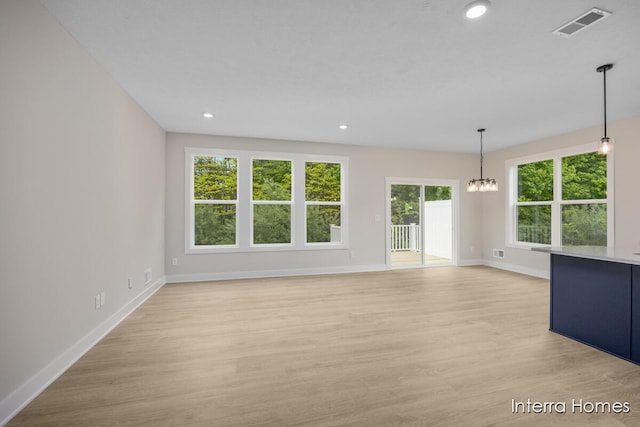 3341 Kings River St SW Unit 40, Wyoming, MI 49418 - unfurnished living room with a chandelier, baseboards, light wood-style flooring, and recessed lighting