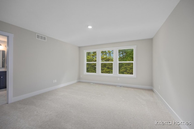 3341 Kings River St SW Unit 40, Wyoming, MI 49418 - spare room featuring light carpet, baseboards, and recessed lighting