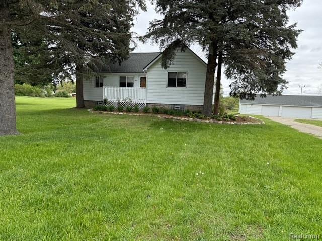 6600 Jefferson Rd, North Branch, MI 48461 - view of front of property featuring a front lawn, a garage, and a porch