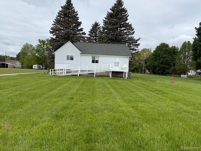 6600 Jefferson Rd, North Branch, MI 48461 - back of house featuring a lawn