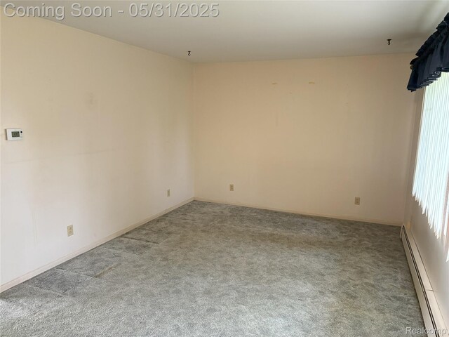 8865 E Bennington Rd, Durand, MI 48429 - carpeted spare room featuring a baseboard radiator and baseboards