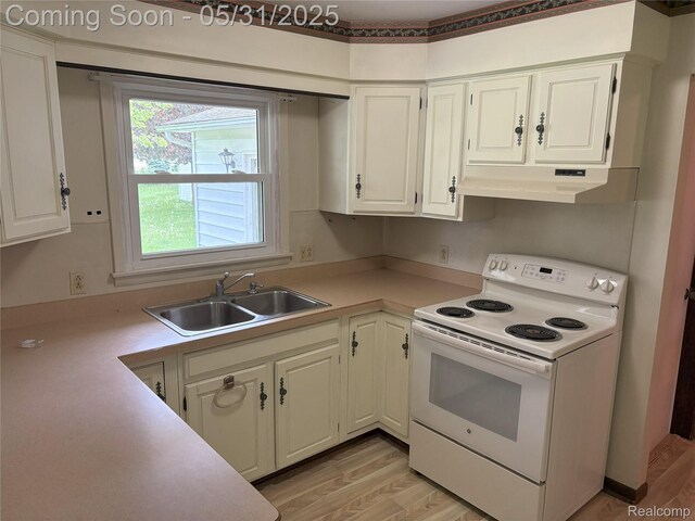 8865 E Bennington Rd, Durand, MI 48429 - kitchen with white electric stove, under cabinet range hood, a sink, and light wood-style flooring