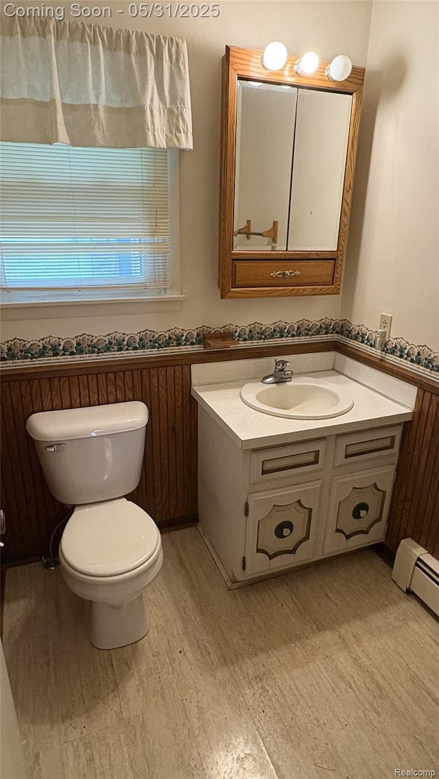 8865 E Bennington Rd, Durand, MI 48429 - bathroom featuring toilet, vanity, and wood finished floors