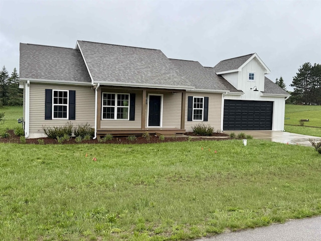 8524 S Elizabeth Dr, Maple City, MI 49664 - view of front of property with a garage, a shingled roof, board and batten siding, a front yard, and concrete driveway