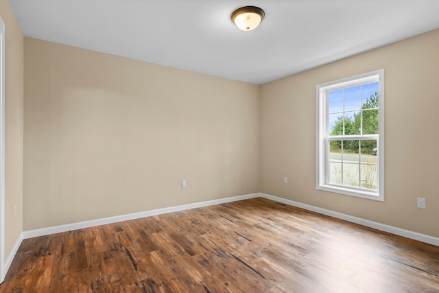 8524 S Elizabeth Dr, Maple City, MI 49664 - empty room featuring wood finished floors and baseboards
