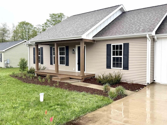 8524 S Elizabeth Dr, Maple City, MI 49664 - single story home with covered porch, a shingled roof, board and batten siding, and a front lawn