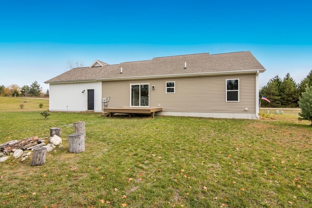 8524 S Elizabeth Dr, Maple City, MI 49664 - back of house featuring a wooden deck and a lawn
