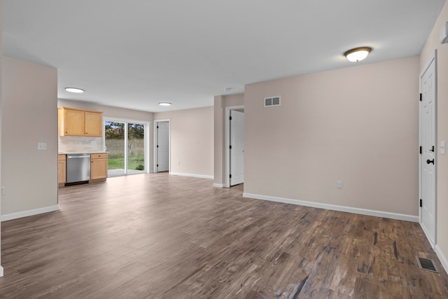 8524 S Elizabeth Dr, Maple City, MI 49664 - unfurnished living room featuring dark wood-type flooring and baseboards
