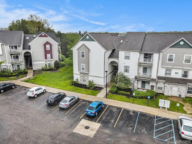 15200 Silver Pkwy Unit 101, Fenton, MI 48430 - view of property featuring uncovered parking and a residential view