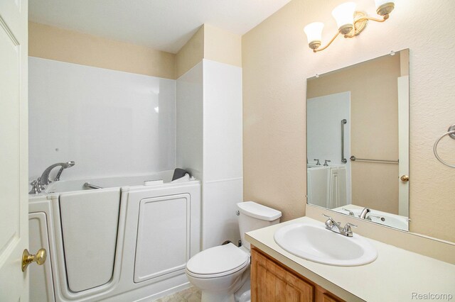 15200 Silver Pkwy Unit 101, Fenton, MI 48430 - bathroom featuring a garden tub, vanity, and toilet