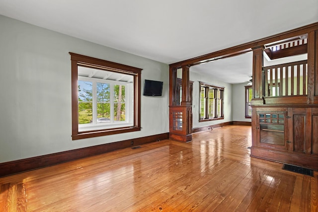 8001 S Jackson Rd, Jackson, MI 49201 - unfurnished living room featuring baseboards and light wood-type flooring