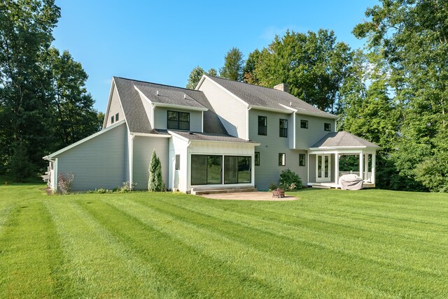 6606 Spaniel Dr, Kalamazoo, MI 49009 - back of house with a patio area, a yard, a shingled roof, and french doors