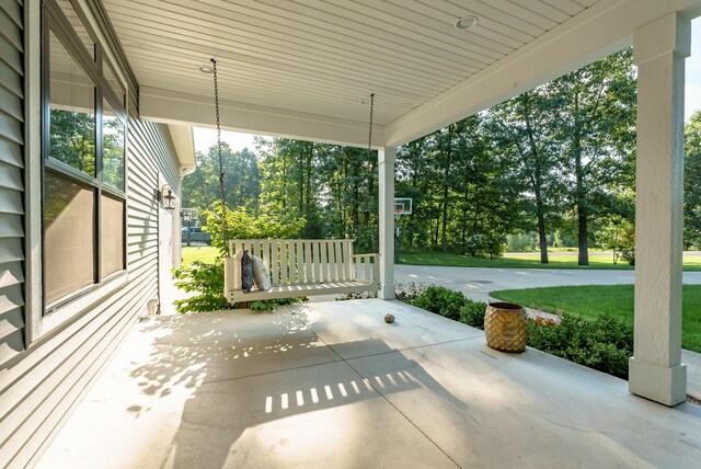 6606 Spaniel Dr, Kalamazoo, MI 49009 - covered porch with view of wooded area and a lawn