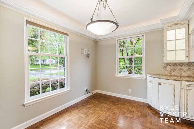 600 Plymouth Ave SE, East Grand Rapids, MI 49506 - unfurnished dining area featuring plenty of natural light, ornamental molding, and baseboards