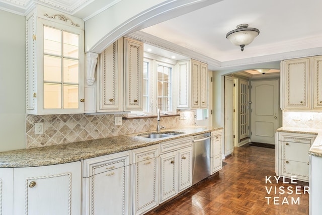 600 Plymouth Ave SE, East Grand Rapids, MI 49506 - kitchen featuring stainless steel dishwasher, cream cabinets, crown molding, a sink, and plenty of natural light