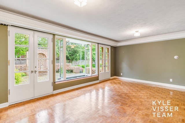 600 Plymouth Ave SE, East Grand Rapids, MI 49506 - empty room with french doors, baseboards, crown molding, healthy amount of natural light, and a textured ceiling
