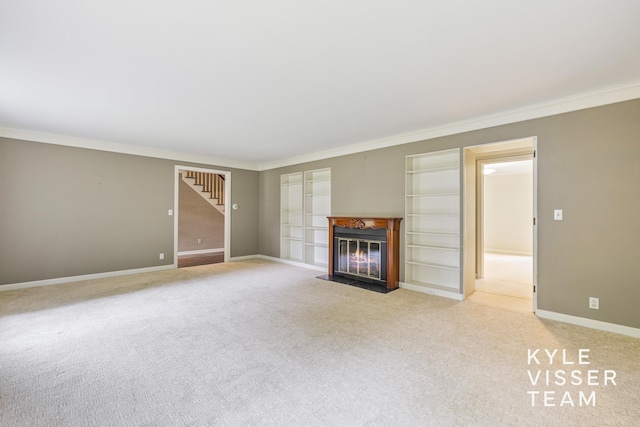 600 Plymouth Ave SE, East Grand Rapids, MI 49506 - unfurnished living room with crown molding, light colored carpet, a fireplace with flush hearth, stairway, and baseboards