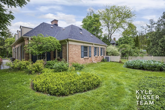 600 Plymouth Ave SE, East Grand Rapids, MI 49506 - view of property exterior with brick siding, a shingled roof, a chimney, and central air condition unit