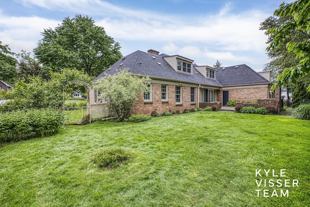 600 Plymouth Ave SE, East Grand Rapids, MI 49506 - rear view of property with brick siding, a chimney, and a shingled roof