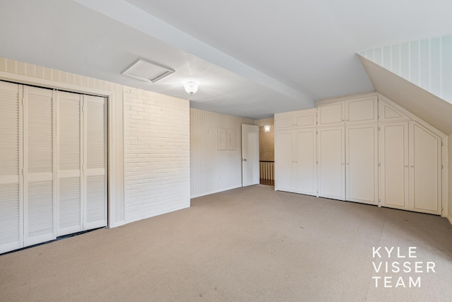 600 Plymouth Ave SE, East Grand Rapids, MI 49506 - unfurnished bedroom with light carpet, attic access, and a closet