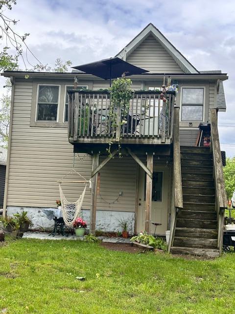 6 Vine St, Hillsdale, MI 49242 - rear view of property with stairs, a deck, and a lawn