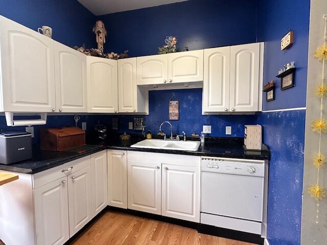 6 Vine St, Hillsdale, MI 49242 - kitchen featuring dishwasher, a sink, dark countertops, and light wood-type flooring