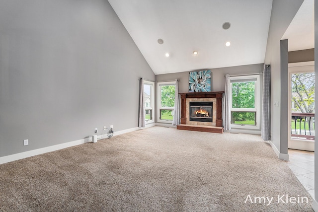 1657 N Bay Dr, Hudsonville, MI 49426 - unfurnished living room featuring light carpet, baseboards, a glass covered fireplace, high vaulted ceiling, and recessed lighting