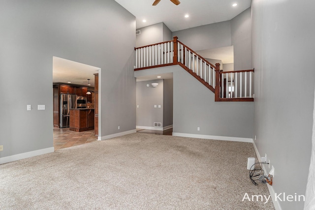 1657 N Bay Dr, Hudsonville, MI 49426 - unfurnished living room with light carpet, a ceiling fan, recessed lighting, stairs, and baseboards