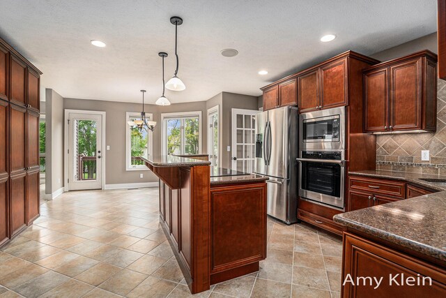1657 N Bay Dr, Hudsonville, MI 49426 - kitchen featuring stainless steel appliances, backsplash, baseboards, recessed lighting, and hanging light fixtures