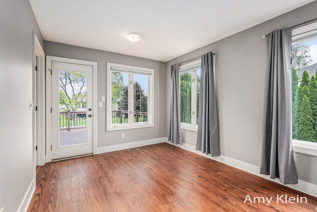 1657 N Bay Dr, Hudsonville, MI 49426 - empty room featuring baseboards and wood finished floors