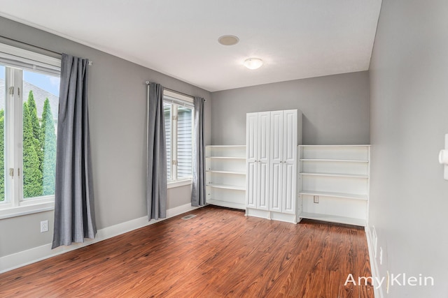 1657 N Bay Dr, Hudsonville, MI 49426 - spare room featuring wood finished floors, plenty of natural light, and baseboards