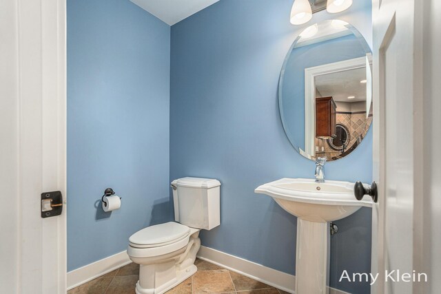 1657 N Bay Dr, Hudsonville, MI 49426 - bathroom featuring toilet, baseboards, and tile patterned floors