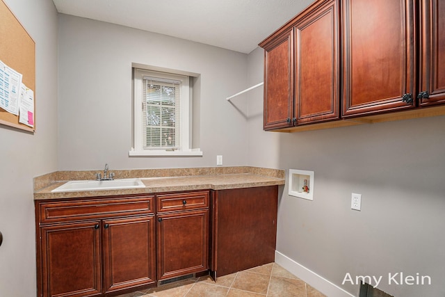 1657 N Bay Dr, Hudsonville, MI 49426 - laundry room featuring washer hookup, cabinet space, light tile patterned floors, and baseboards