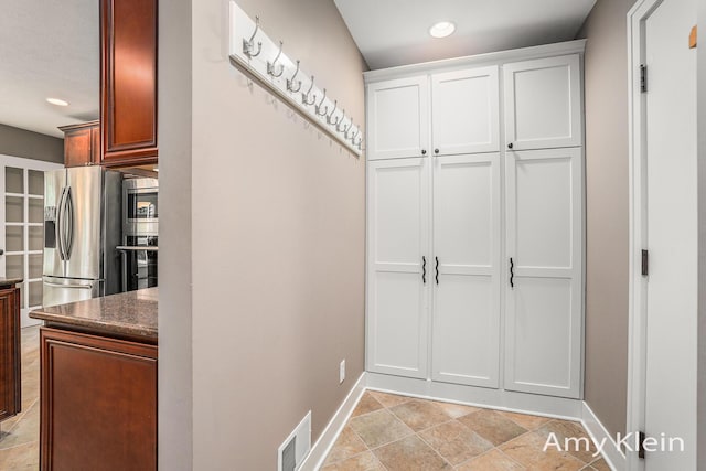 1657 N Bay Dr, Hudsonville, MI 49426 - mudroom featuring baseboards, recessed lighting, and light stone finish flooring