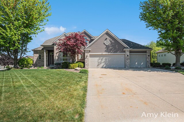 1657 N Bay Dr, Hudsonville, MI 49426 - traditional home featuring concrete driveway, a garage, a front yard, and stone siding