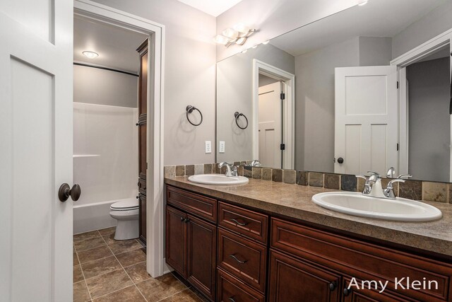 1657 N Bay Dr, Hudsonville, MI 49426 - bathroom with double vanity, toilet, and shower / tub combination