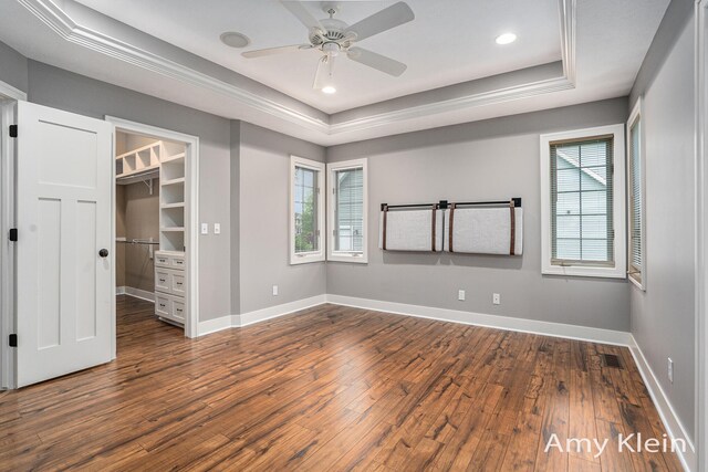 1657 N Bay Dr, Hudsonville, MI 49426 - unfurnished bedroom featuring dark wood-style floors, multiple windows, a tray ceiling, baseboards, and recessed lighting