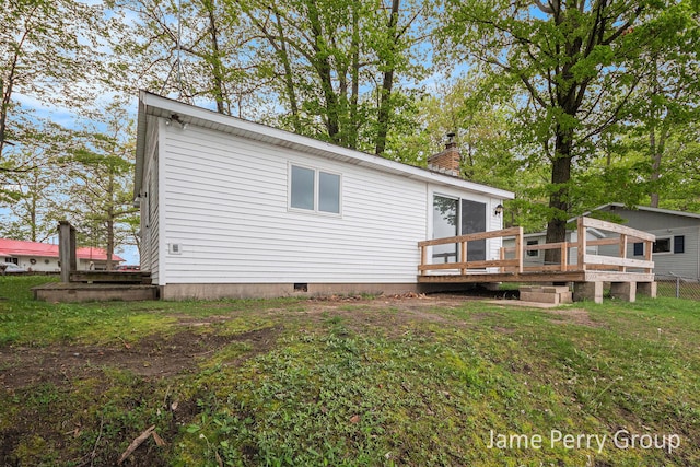 1760 S Colonel Point Dr, Crystal, MI 48818 - rear view of property featuring a wooden deck, a chimney, and crawl space