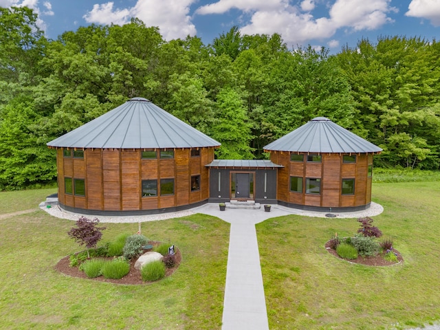18619 130th Ave, Fruitport, MI 49415 - rear view of house with a lawn, a standing seam roof, and metal roof