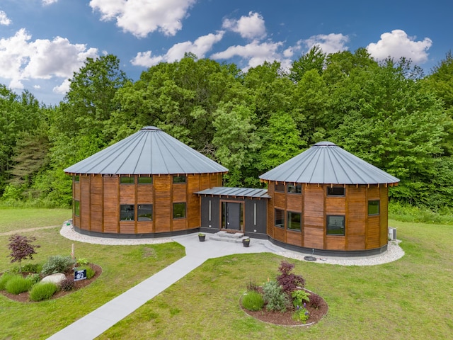 18619 130th Ave, Fruitport, MI 49415 - back of house with a standing seam roof, a yard, metal roof, and a wooded view