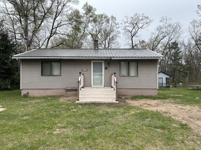 3092 S M 37, Baldwin, MI 49304 - view of front of property featuring metal roof and a front lawn