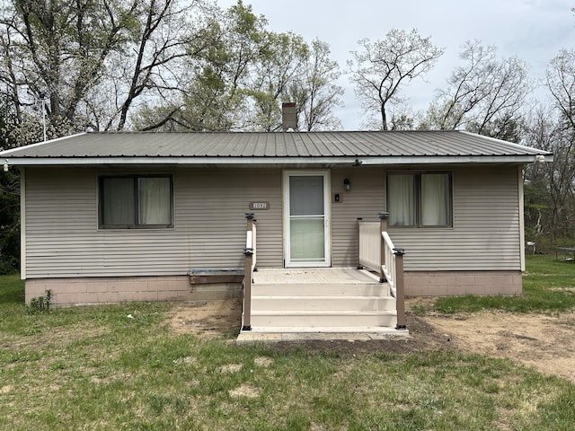 3092 S M 37, Baldwin, MI 49304 - bungalow-style house featuring metal roof and a front lawn
