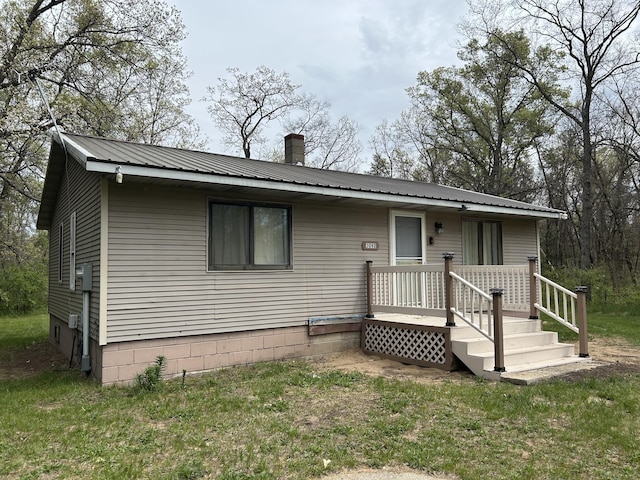 3092 S M 37, Baldwin, MI 49304 - view of front facade featuring metal roof and a chimney