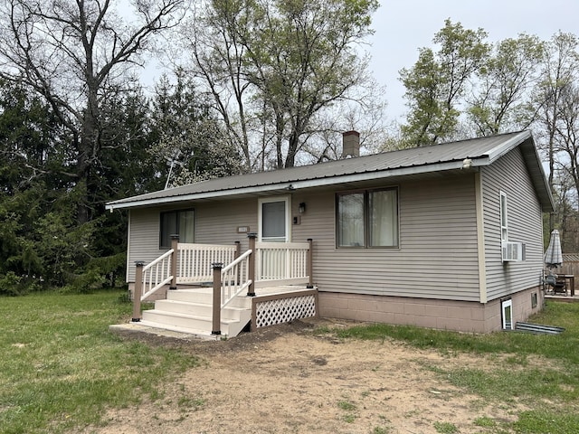 3092 S M 37, Baldwin, MI 49304 - view of front of home with metal roof, a chimney, a front yard, and cooling unit