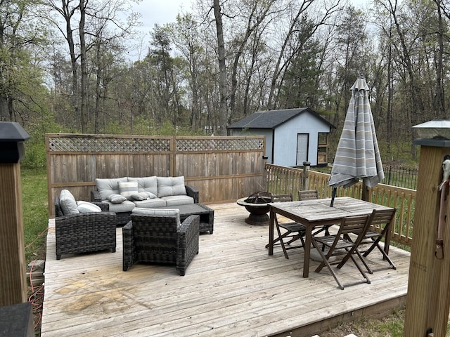 3092 S M 37, Baldwin, MI 49304 - wooden terrace with outdoor dining space and an outdoor living space with a fire pit