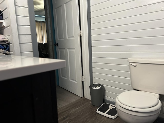 3092 S M 37, Baldwin, MI 49304 - bathroom featuring toilet, wood finished floors, vanity, and wood walls